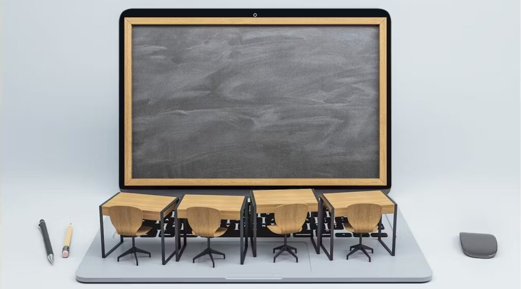 A MacBook with a chalkboard on the display and four student desks and seats on the trackpad. There is a pen and pencil on the left and an Apple Magic Mouse on the right.